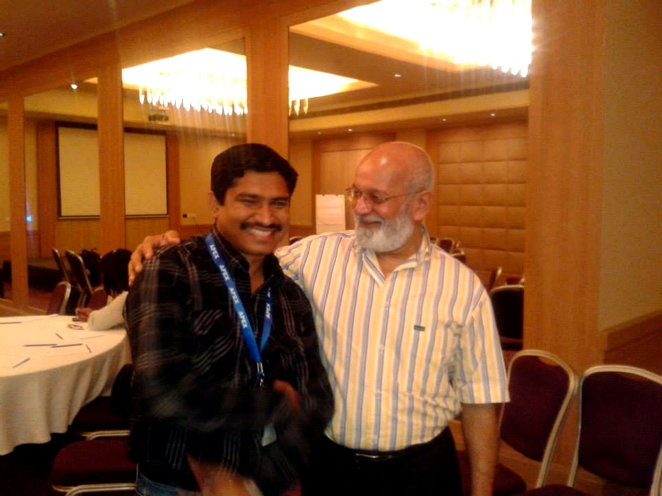 Ravi Thota with a senior leader at a conference venue